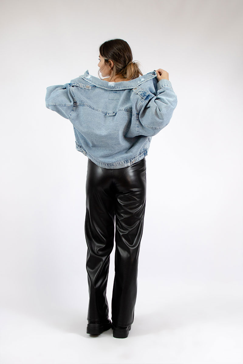 a blue denim jacket with our rahaf leather pants from the back